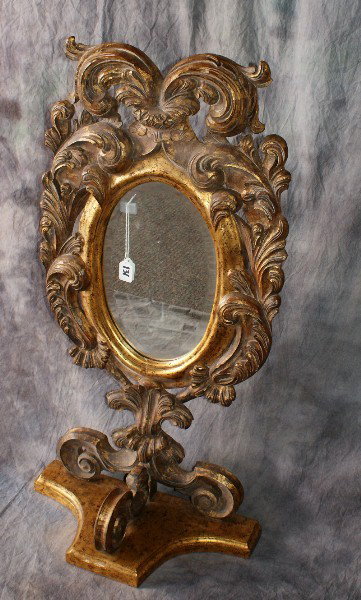Continental Rococo style carved gilt-wood table or: Continental Rococo style carved gilt-wood table or vanity beveled mirror. H: 38 1/2" W: 20" D: 10"