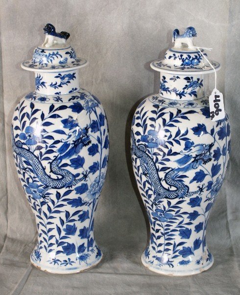 Pr Antique Chinese Canton porcelain baluster-form : Pair of Antique Chinese Canton porcelain baluster-form vases and covers, decorated with dragons and leafy foliage, the covers with Foo dog finials, four character mark, 19th century or earlier. H: 14"