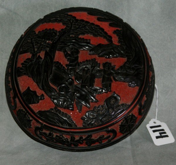 Chinese red and black carved cinnabar covered box: Chinese red and black carved cinnabar covered box . H: 4" D: 7.5"