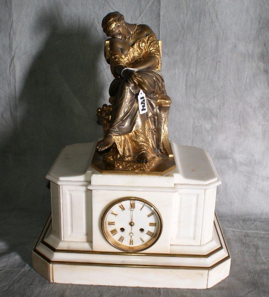 Bronze and marble figural clock with a bronze per: Bronze and marble figural clock with a bronze persian woman sitting in a chair on top of a clock in a marble case, signed "J. Cavelier" and foundry marked. H:20. 5" W:16" D:10. 5".