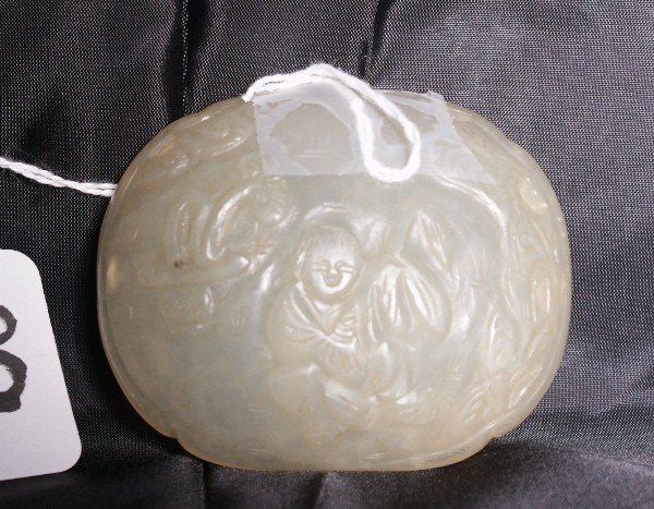Antique white jade oval plaque with carving of fi: Antique white jade oval plaque with carving of figure in garden. H:2.25" W:3".