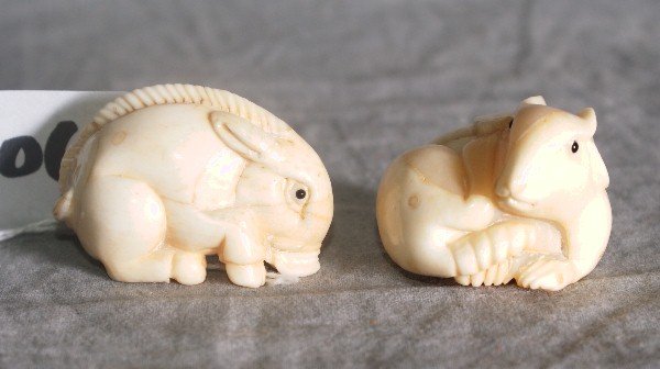Pair of marine ivory animal netsukes.: Pair of marine ivory animal netsukes.