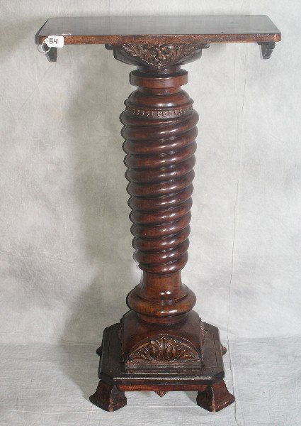 19th C barley twist mahogany pedestal with carved mask: 19th C barley twist mahogany pedestal with carved masks. H:38.5" W:22.5" D:12"