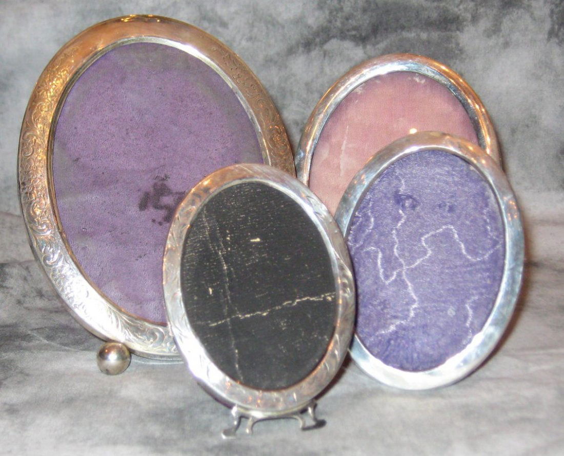 Four sterling silver oval picture frames, two floral en: Four sterling silver oval picture frames, two floral engraved and two plain. Largest: 4 ½” x 6” smallest: 3 ½” x 2 ¾”