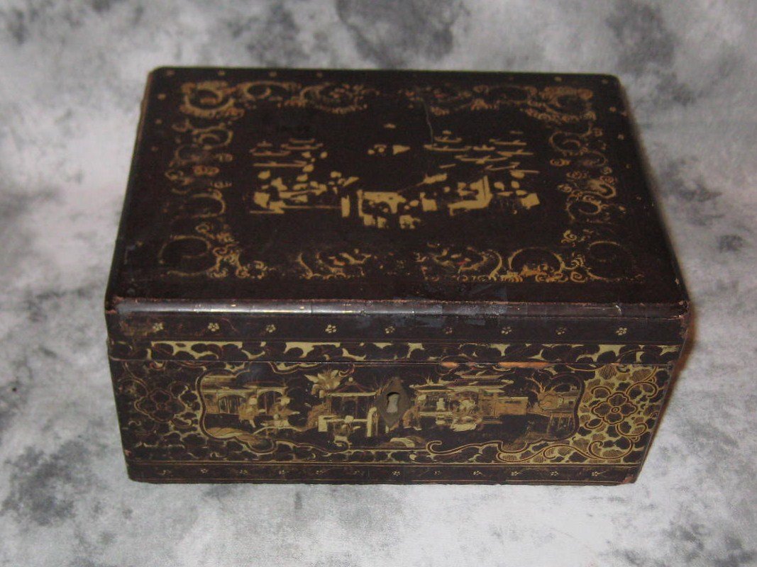 An English Chinoiserie decorated papier mache: An English Chinoiserie decorated papier mache double divide tea caddy with pewter covers and wells. H: 3” W: 7 ¾” D: 5 ¾”
