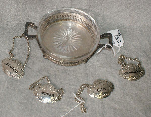 Four silver decanter tags and one silver and glass coas: Four silver decanter tags and one silver and glass coaster. Coaster H:1.5" D:7"