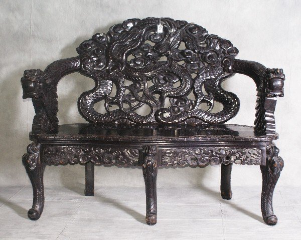 Chinese heavily carved 19th C wood settee with dragon : Chinese heavily carved 19th C wood settee with dragon form arms. H:38.5" W:48.5" D:25"