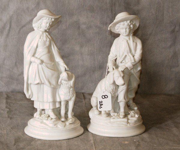 Pair of parian porcelain figures of children with dogs.: Pair of parian porcelain figures of children with dogs. H:10"