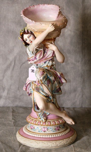 Painted Parian porcelain figure holding a seashell,: Painted Parian porcelain figure holding a seashell, with a mark of HC on the underside. H:16"