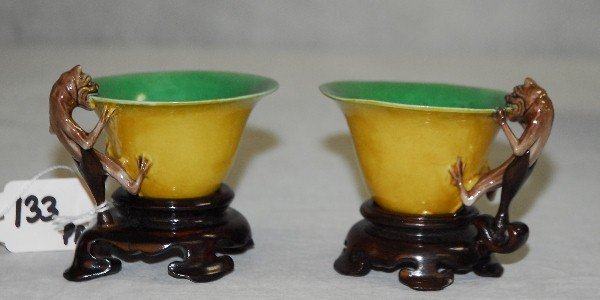 Pair Chinese glazed biscuit libation cups with applied: Pair Chinese glazed biscuit libation cups with applied brown/glazed chilong handles , possibly Kangxi with later stands. H:3" D:3.75" identical pair sold in Sothebys Amsterdam in may 11 1999 sale # am