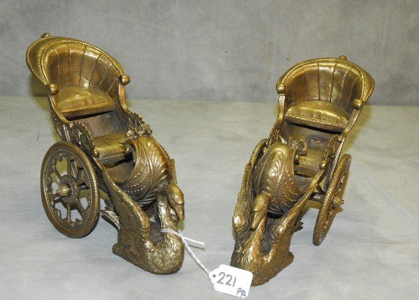 Pair of bronze swan 2 wheel buggys. H:8. 25" L:11": Pair of bronze swan 2 wheel buggys. H:8. 25" L:11"