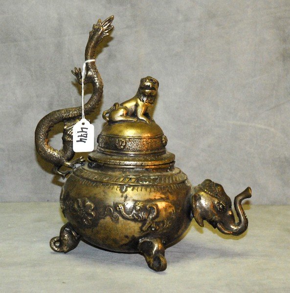 Silvered metal tea pot form canister with various: Silvered metal tea pot form canister with various applied animals.H:12.5" W:7.5"