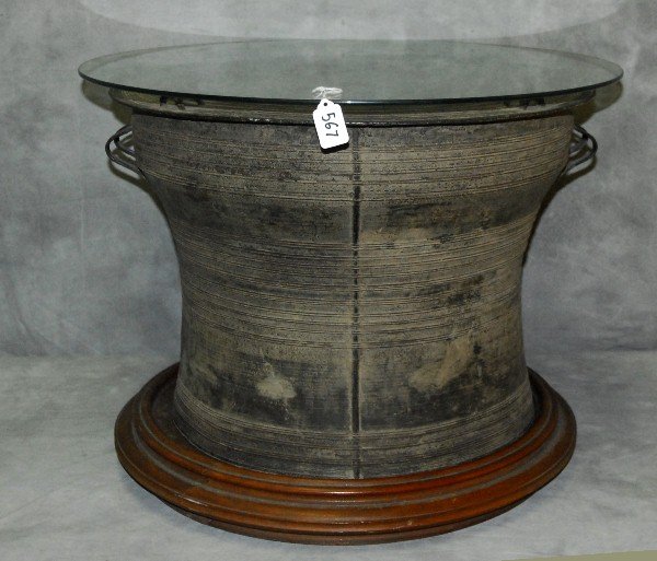 Thai bronze rain drum glass top table on teakwood base.: Thai bronze rain drum glass top table on teakwood base. H:21" D:24.5"