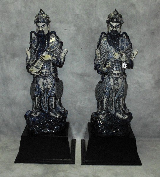 Large pair Chinese blue and white ceramic figures on: Large pair Chinese blue and white ceramic figures on wood bases. Statue H:42" one with damage to fingers as scene in last picture