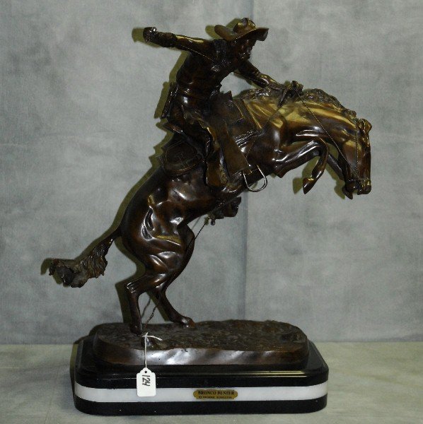 After Frederick Remington "Bronco Buster" bronze: After Frederick Remington "Bronco Buster" bronze sculpture on marble base. Bears signature on base. H:24" W:20.25 D:9.25"