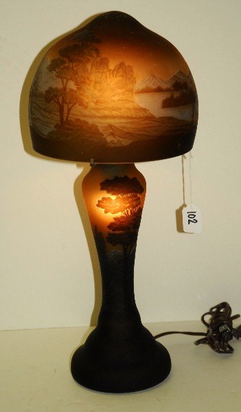 Signed Galle cameo art glass lamp with horses in: Signed Galle cameo art glass lamp with horses in pasture design in relief. H:15" D:9"