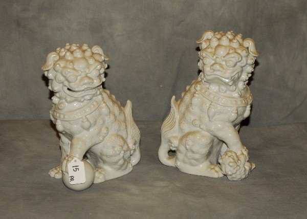 Pair of Chinese blanc de chine porcelain Foo Dogs. H:: Pair of Chinese blanc de chine porcelain Foo Dogs. H: 10.25"