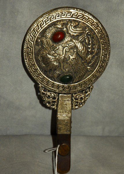 Antique Chinese silvered and jeweled hand mirror on a: Antique Chinese silvered and jeweled hand mirror on a jade belt buckle handle. L: 9"