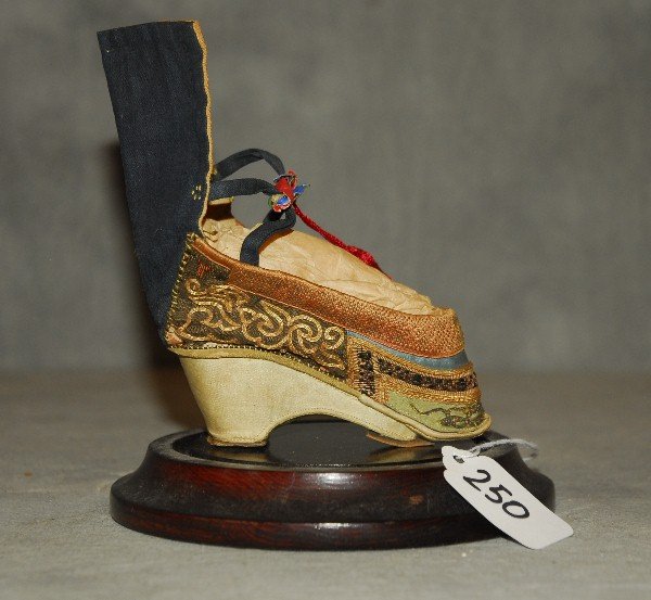 19th c. or earlier Chinese shoe, in a protective glass: 19th c. or earlier Chinese shoe, in a protective glass dome case. H: 6"