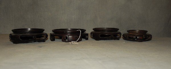 4 Chinese carved hardwood stands. Largest H: 1.75" D:: 4 Chinese carved hardwood stands. Largest H: 1.75" D: 5.75"