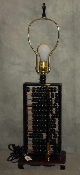 Chinese carved wood abacus mounted as a lamp. Overall:: Chinese carved wood abacus mounted as a lamp. Overall: 31"