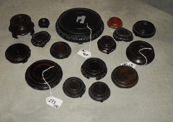 16 Chinese carved stands. Largest H: 1.75" D: 6.5" (1 of 2)