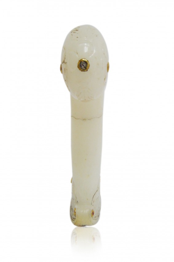 A MUGHAL WHITE JADE DAGGER HILT 18TH CENTURY INDIA: A flowering stem that follows the curve of the rounded end and branches out to decorate the sides, side's decorated with gem , ruby & emerald . Meaurment : 13.5 cm