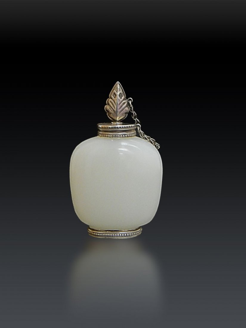 A Rare White Jade Snuff Bottle China 18th/19th Century: A Rare Mughal Style Chinese White Jade Snuff Bottle 18th/19th Century , Of rounded rectangular shape, the interior well-hollowed, the even white stone shown to advantage by the unadorned surfaces, Sil