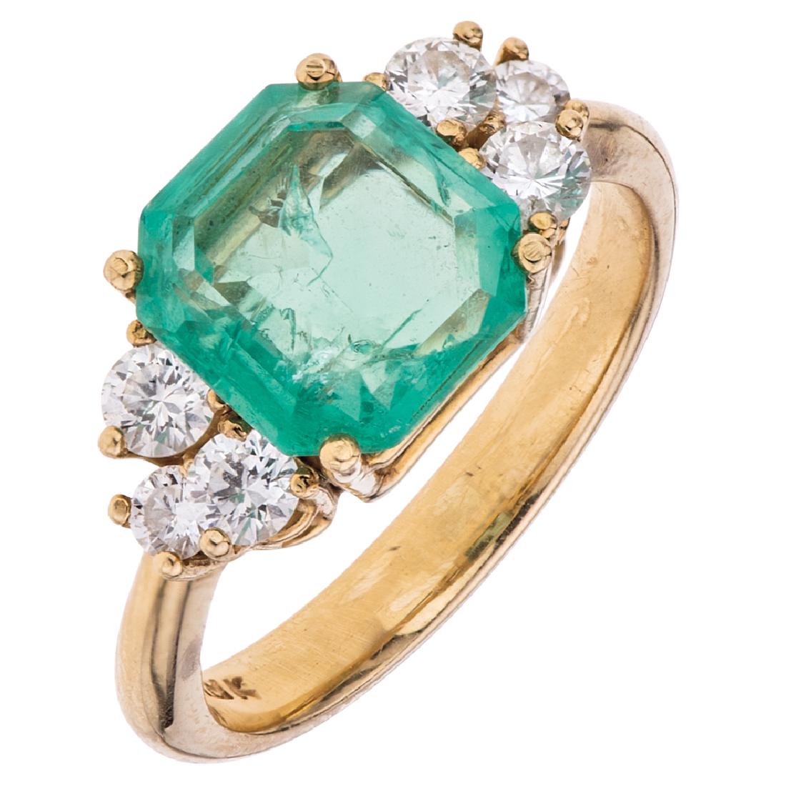 An 18K yellow gold ring with 1 emerald cut emerald 1.90: An 18K yellow gold ring with 1 emerald cut emerald 1.90 carats and 6 diamonds.