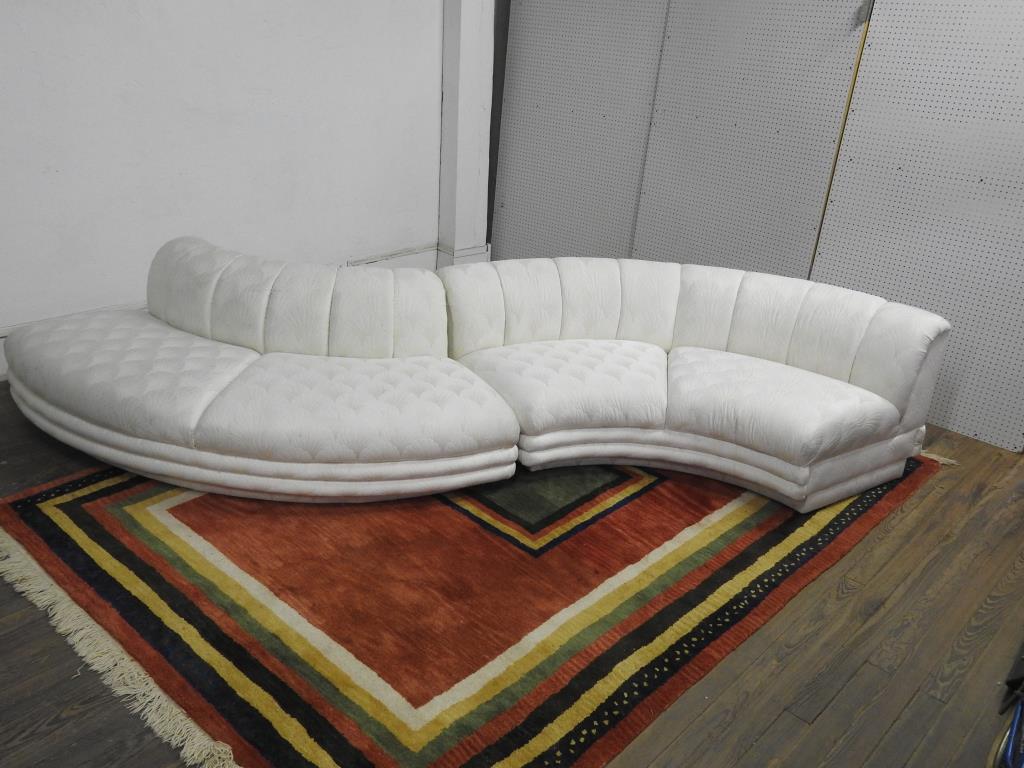Vladimir Kagan "Snake" 2 piece Sectional: Two piece serpentine form sectional sofa in white fabric. In good condition. Unsigned Directional furniture. 30"H X 159"W X 48"D.