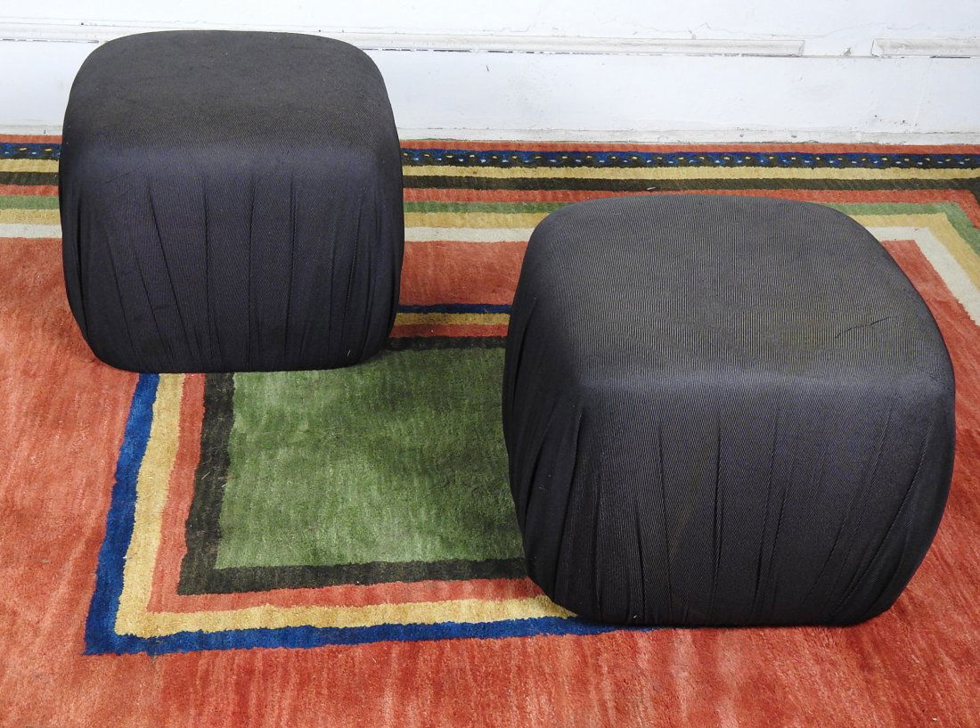 Pr. Karl Springer Style Poof Ottomans: Black fabric covering, some discoloration and stains. 17 1/2H X 22"W X 22:D.