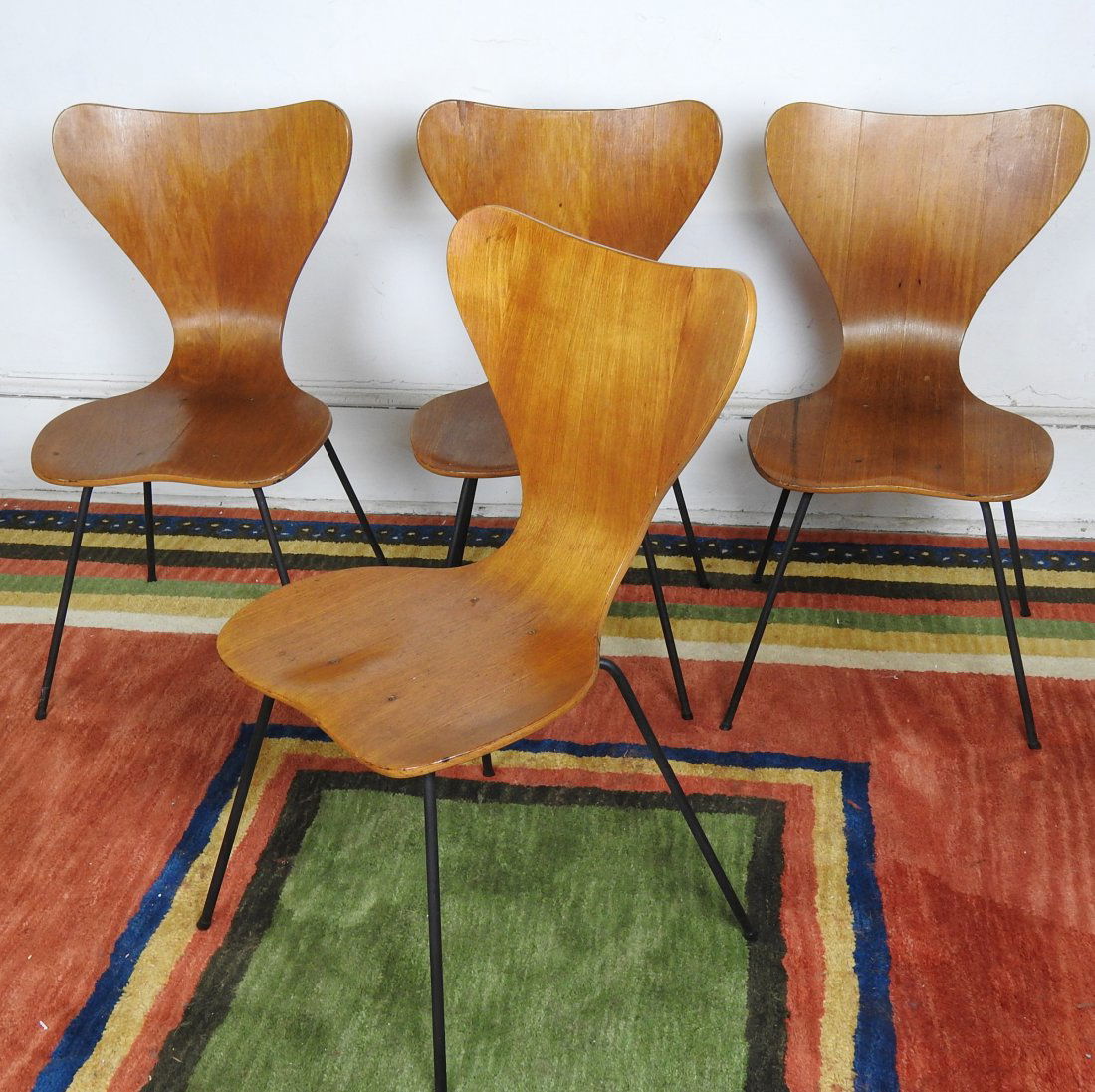 4 Arnie Jacobsen Chairs: Fritz Hansen, Denmark. Molded plywood on metal base. Some veneer loss, otherwise in good condition. 32"H X 17 1/2"W X 15"D.