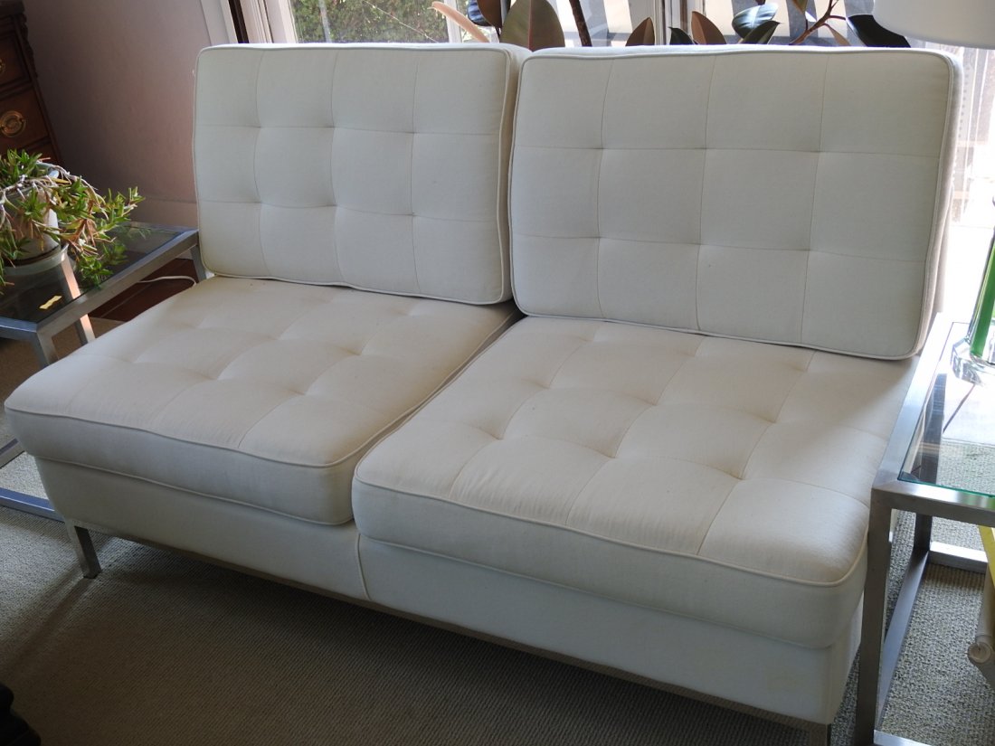 KNOLL STYLE SOFA: Knoll style open arm sofa with off-white fabric coverings and a polished metal base. Sofa is in good condition. Measurements are 31in x 57in x 30in with a seat height of 16in.