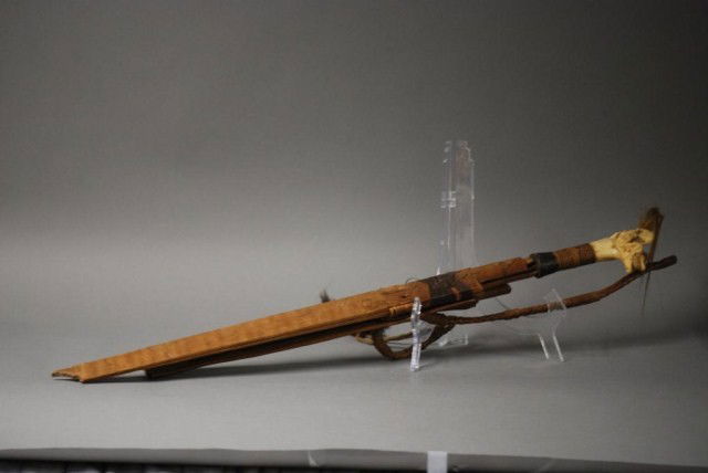 ANTIQUE MACHETE AND SCABBARD: Antique Machete and Scabbard, carved bone handle with braided hair end, carved wood scabbard, machete is 27" long, losses.