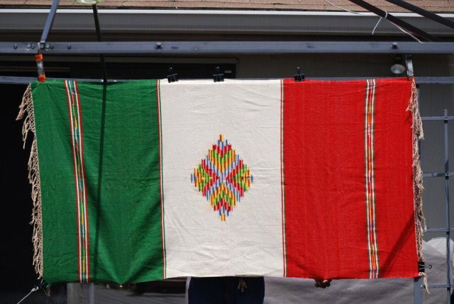 ANTIQUE SOUTHWESTERN BLANKET: Antique Southwestern Blanket, red, white and green, Multi-colored center medallion, some minor fabric separation, 74" x 38".