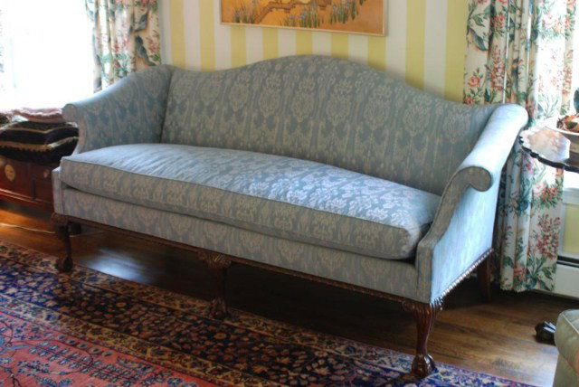 HICKORY CHAIR CO. CHIPPENDALE STYLE COUCH: Chippendale Style Camel Back Couch by Hickory Chair Co., pale blue fabric with single down cushion, exposed mahogany gadrooned carved frame, ball and claw feet in the front, in good condition, 28" ove