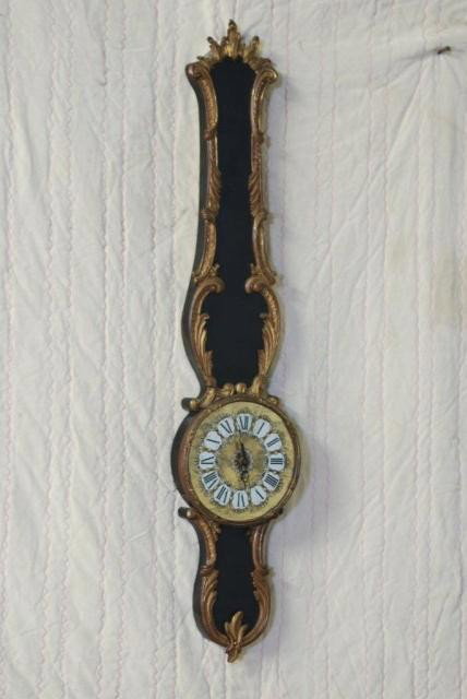 LOUIS XV STYLE WALL CLOCK: Ebonized wood with bronze mounts, eglomise dial, and newer works, 42"H x 8-1/2"W. In good condition.