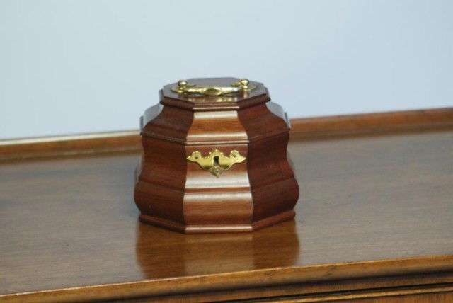 C.W. KITTINGER TEA CADDY: Mahogany with brass handled hinged top, 5 1/2"W x 5"H x 5 1/2"D. In good condition.