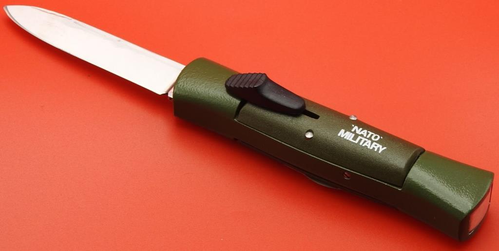 NATO Military Switchblade Knife: This is a NATO Military Switchblade Knife with a green plastic handle. The knife features a picklock stiletto knife. The switchblade is in good condition with a strong spring release. The knife measur