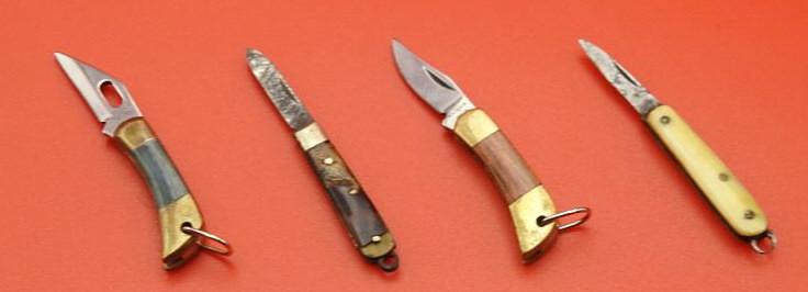 Miniature Knife Lot: Two of the knives have plastic handles. The knives feature picklock stiletto style blades. The switchblades are in good condition with a strong spring action. The knives measure 1 1/2" with a 1/2"