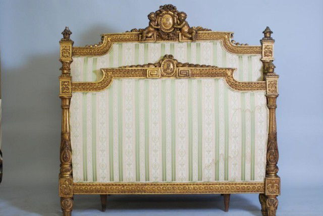 ANTIQUE LOUIS XVI STYLE GILTWOOD BED: Headboard, footboard, 2-rails, carved double cherub crest, green striped damask upholstery, signed LeGrande Meuble Public, 18 Ruest Augustin, Bedel & Cie, 58"h x 57 1/2"w, rails 76 1/2" long. Some wea