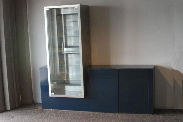 PAUL EVANS CITYSCAPE DISPLAY CABINET: Unusual display cabinet, metal patchwork, 2-door vitrine inset into a blue cabinet base, cabinet has a metal patchwork drawer on the interior, comes apart into 2-sections, 66 1/2"h x 74 1/2"w x 20"d.