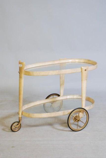 ALDO TURA TEA CART: Goat skin covered with 2-tier glass shelves, 28"h x 33 1/2"w x 23"d. In good condition.