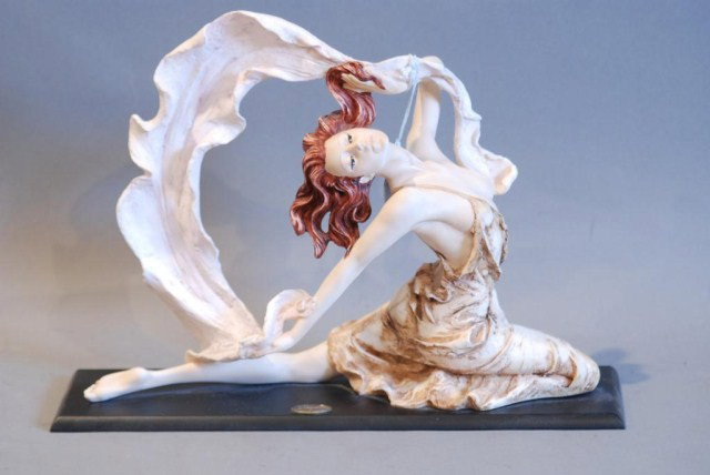 STATUE OF WOMAN IN DRESS w/RIBBON BY A. SANTINI: 11"h x 16"w x 4 1/2"d. In good condition.