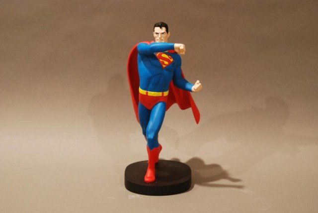 SUPERMAN STATUE IN RUNNING POSE: Superman statue in a running pose, Warner Bros. Studio Store, 13"h x 5"w x 7"d. In good condition.
