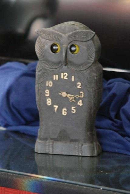 OWL FORM BLACK FOREST STYLE COLCK: Carved wood with mechanical movement and moving eyes. Appears to be in working order. 10 1/4" H X 5' W X 2" D. In good condition.