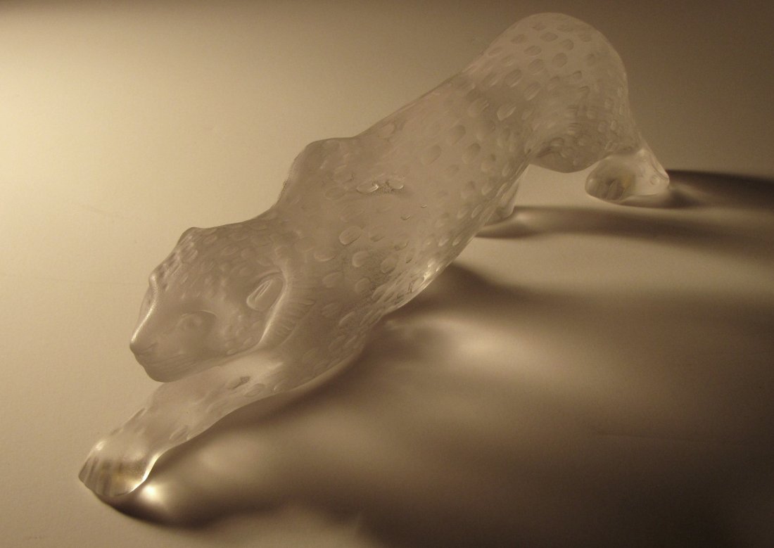 GLASS LALIQUE PANTHER: Cast glass figure of a skulking panther. Plainly signed on the underside: "Lalique France". About fifteen inches long & four inches high. No chips, cracks, dings or bruises; clear & colorless glass wi