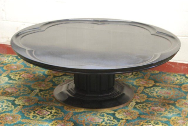 JAMES MONT FOR JOHN WIDDICOMB MFG.COFFEE TABLE: Ebonized hardwood Table with bronze trim ring on base, labeled Wm. Berkey Furniture Co./a division of John Widdicomb Mfg., 17"H X 48"Diameter. Some surface wear, otherwisw in good "as found" condition