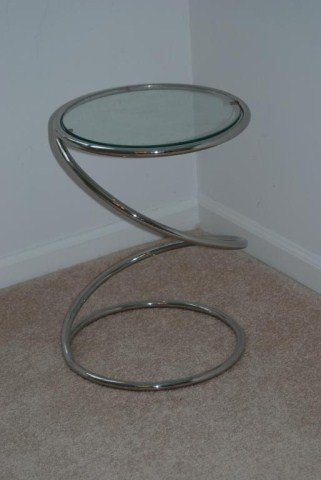 MILO BAUGHMAN DESIGN TABLE: Spiral chrome base with a glass top. In good condition.