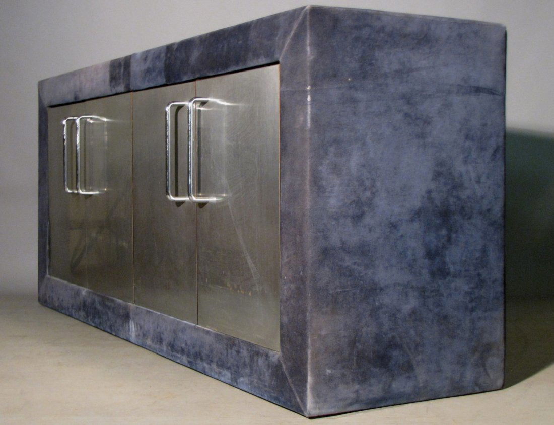 PAUL EVANS STAINLESS STEEL SUEDE SIDEBOARD: Very unusual sideboard upholstered with blue suede, 23"D X 72"W X 32"H. Some fading, metal is bright and clean, even the back is finished!
